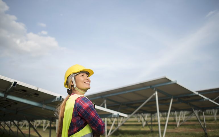 Engineer electric woman checking and maintenance of solar cells.